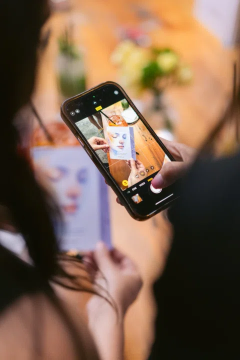 Asistente graba una escena del evento con su teléfono móvil.