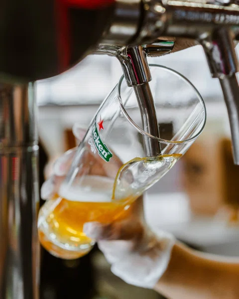 Copa de cerveza llenándose desde dispensador.