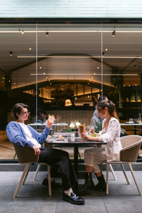 Dos personas conversando en restaurante del hotel.