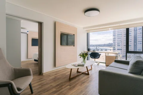 Living de suite de hotel en Viña del Mar con vista urbana.