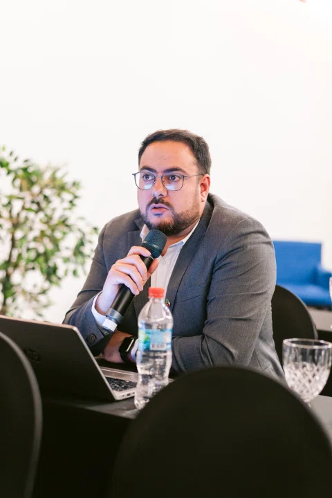 Participante interviene con micrófono durante una sesión.