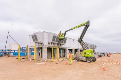 Plataforma elevadora junto a módulo eléctrico en construcción.